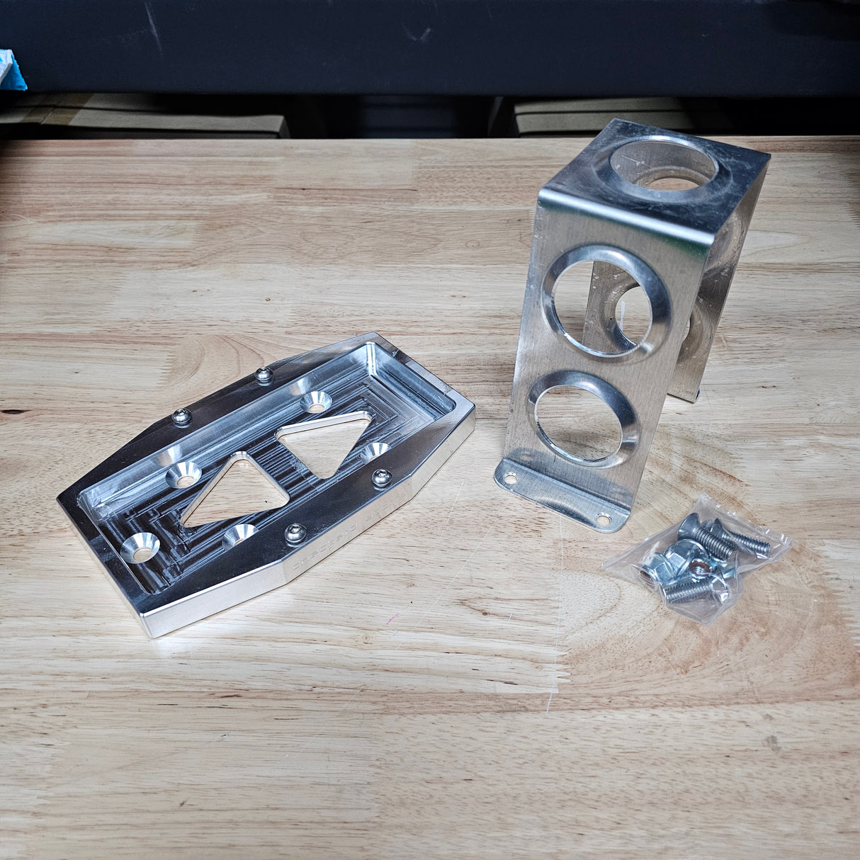 CNC-machined raw billet battery tray with Honda S2000 bolt pattern”