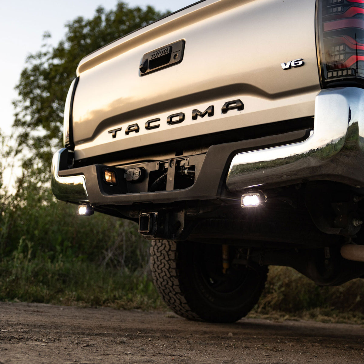 Baja Designs S2 Sport reverse lights installed below the rear bumper of a Toyota Tacoma