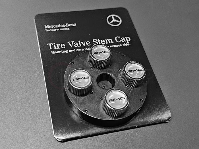 Chrome Mercedes-Benz valve stem caps with black AMG logo on silver face