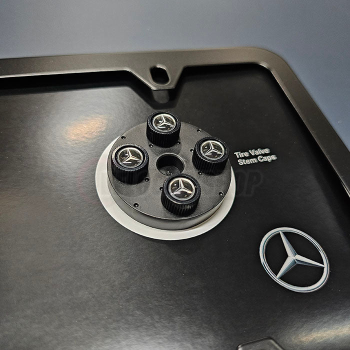 Close-up of Mercedes-Benz logo black valve stem caps included in Star Set