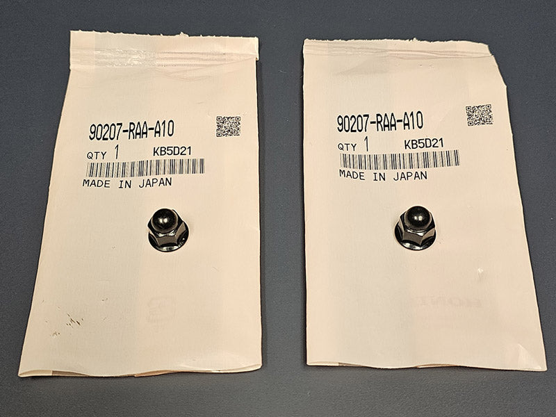 Two OEM K-Series acorn nuts side by side showing factory black finish