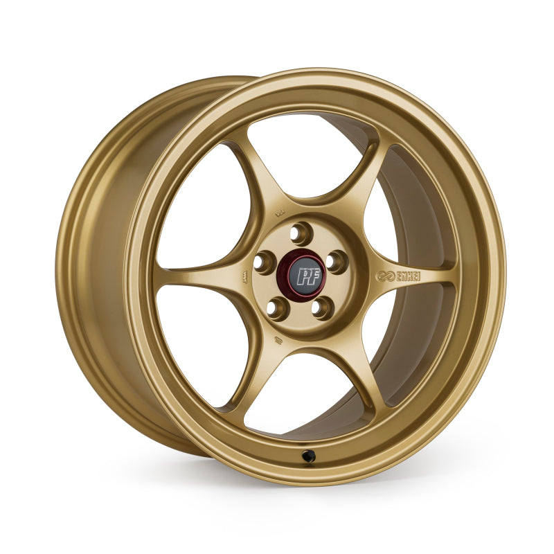 Gold Enkei PF06 15x8 six-spoke wheel with 4x100 bolt pattern