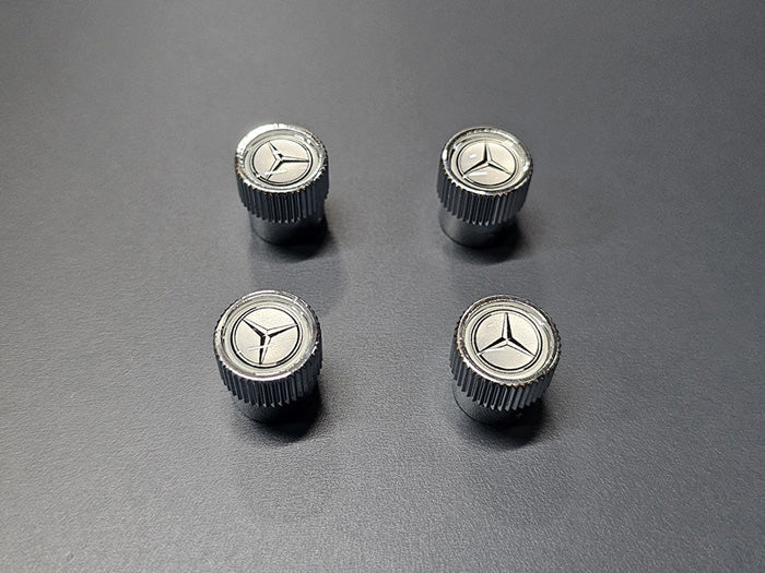 Mercedes-Benz chrome tire valve caps with black star logo on silver face