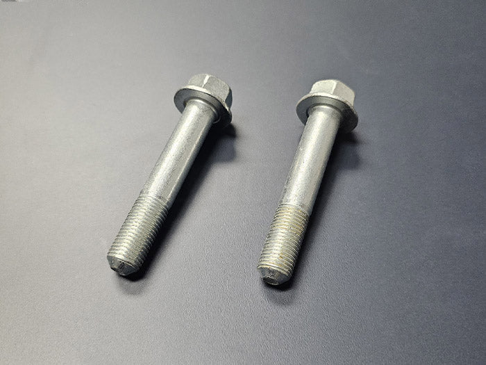 Close-up of OEM Honda rear lower shock bolts showing thread and flange head detail – 2002–2006 Acura RSX