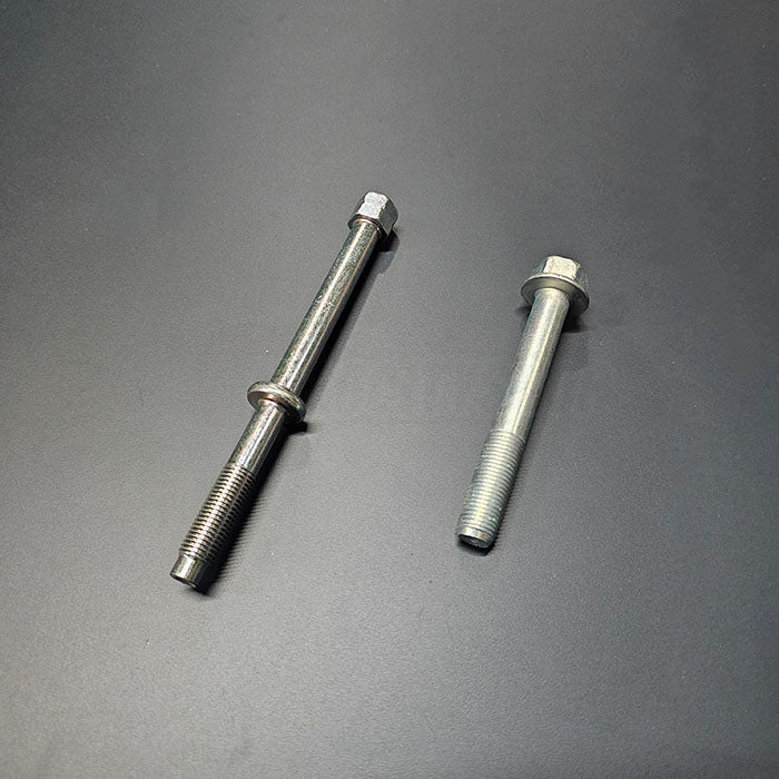 OEM Honda K-Series starter bolts 95701-12085-08 and 90027-PND-A00 side-by-side on dark background