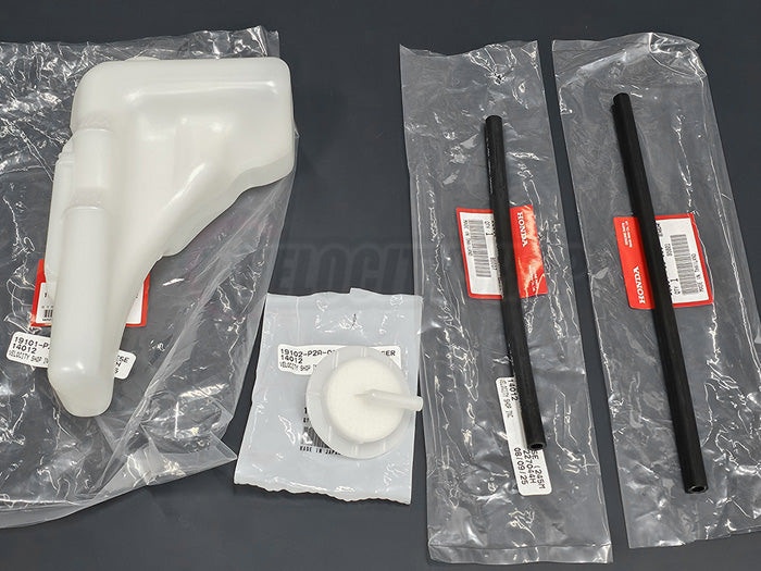 Close-up of coolant reservoir tank with hoses and cap for ’96–’00 Civic in Honda packaging