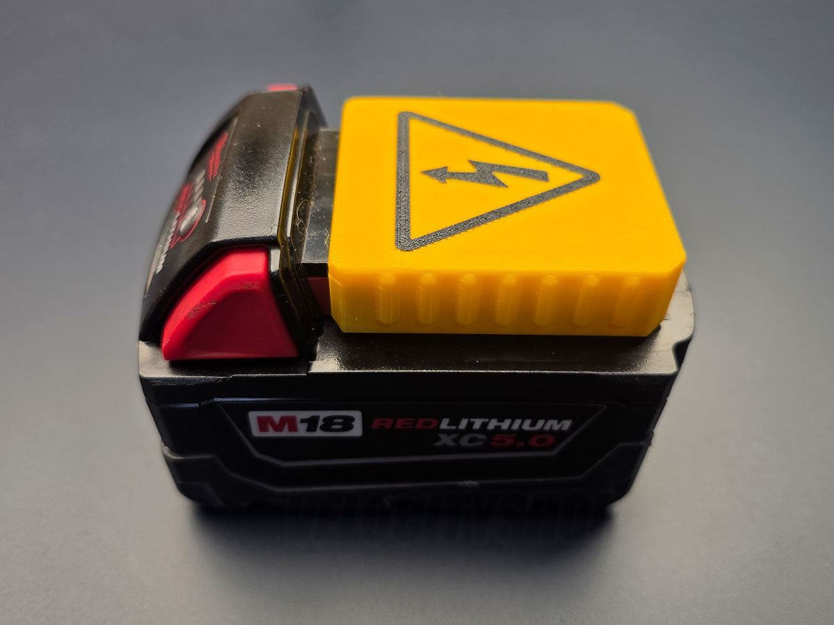 Side view of yellow terminal cover installed on a Milwaukee M18 battery