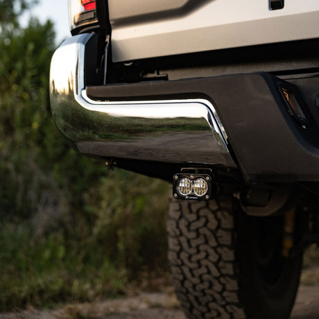 Baja Designs S2 Sport clear Wide Cornering reverse light mounted under a Toyota Tacoma rear bumper
