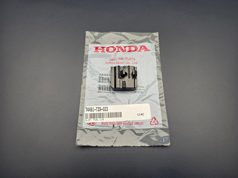 Honda fuel lid clip 74481-TZA-023 front view with OEM packaging