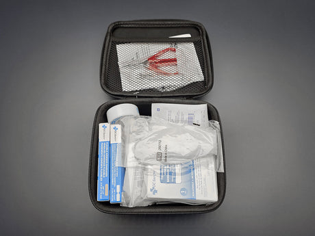 Honda First Aid Kit 08865-FAK-100 opened with basic first-aid supplies inside