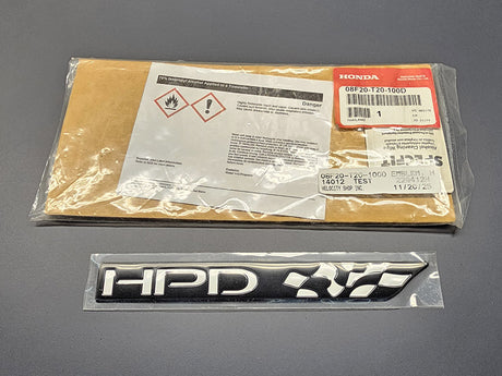 Authentic Honda HPD emblem displayed on official Honda packaging.