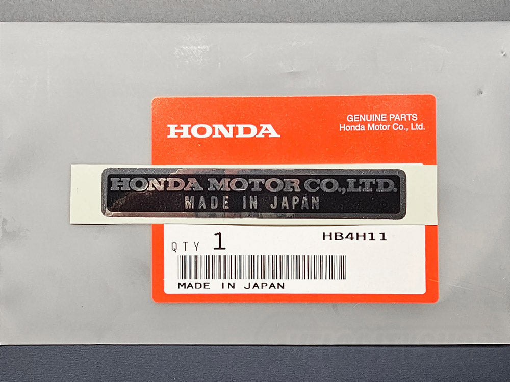 Classic Honda engine bay with genuine “Made in Japan” sticker close up reflective mirror silver