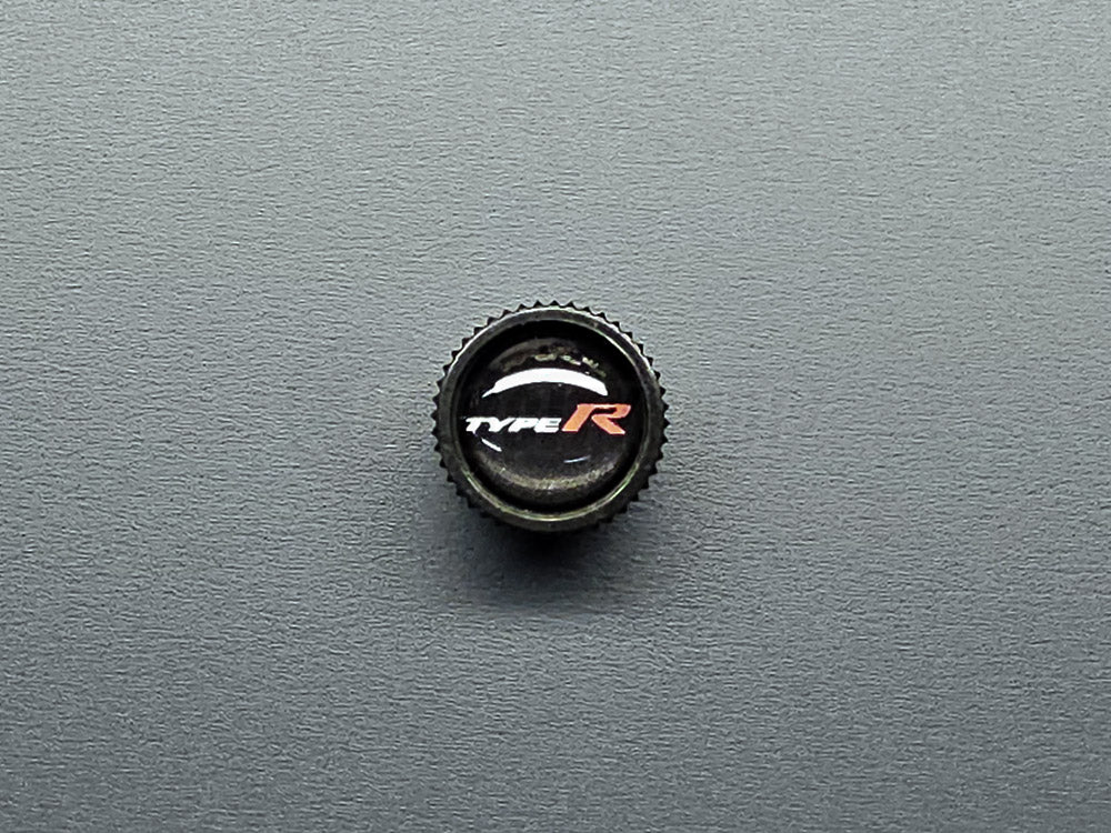 Close-up of Honda Type R valve stem cap black finish