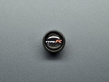 Close-up of Honda Type R valve stem cap black finish