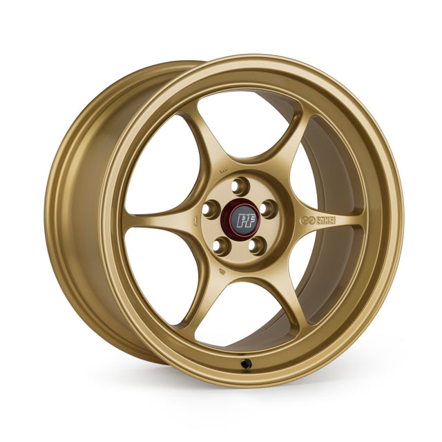 Gold Enkei PF06 15x8 six-spoke wheel with 4x100 bolt pattern