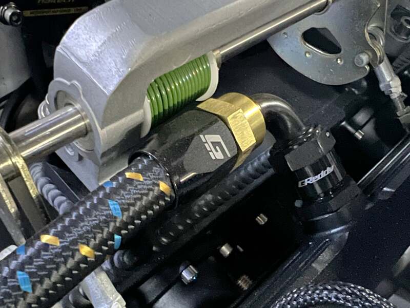 GReddy -10AN 90-degree swivel hose end in black and gold anodized aluminum close up shot