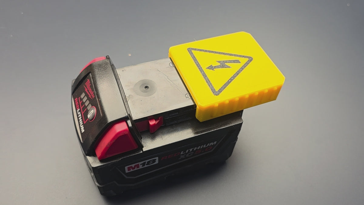 Installing a yellow 3D-printed PETG terminal cover on a Milwaukee M18 battery