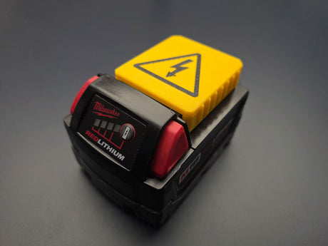 Yellow 3D-printed terminal cover installed on a Milwaukee M18 battery