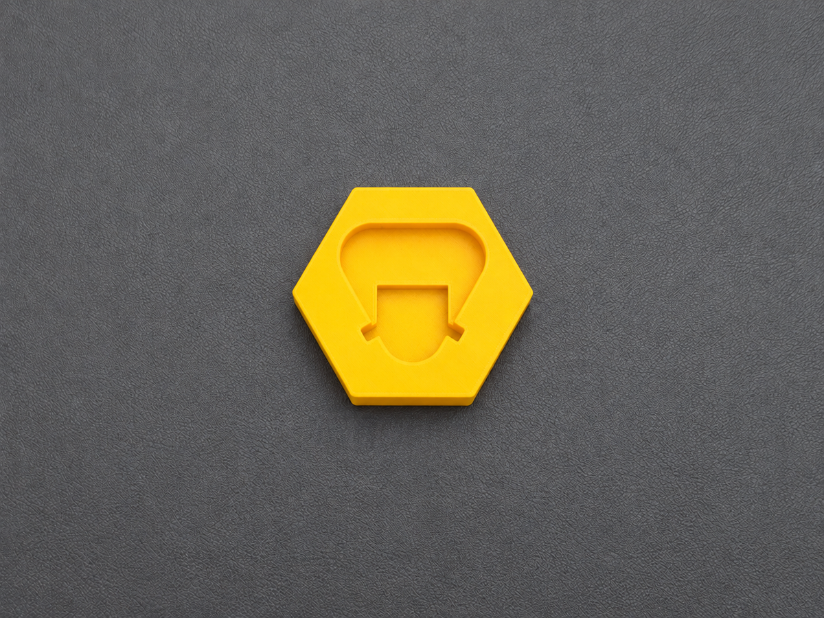 Top view of yellow PETG battery terminal cover for Milwaukee M12 batteries