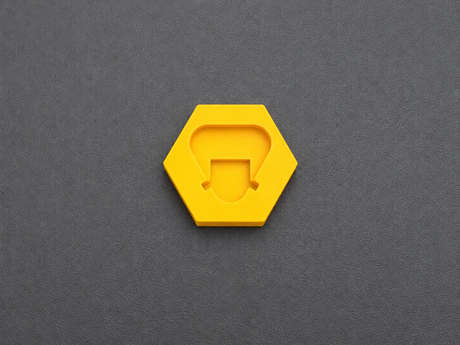 Top view of yellow PETG battery terminal cover for Milwaukee M12 batteries