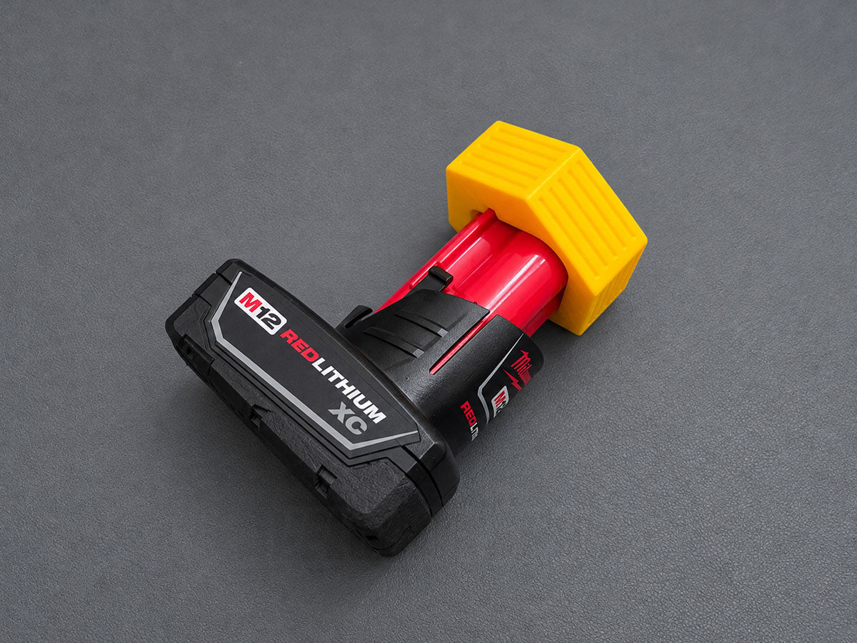 Yellow 3D-printed PETG terminal cover installed on a Milwaukee M12 battery
